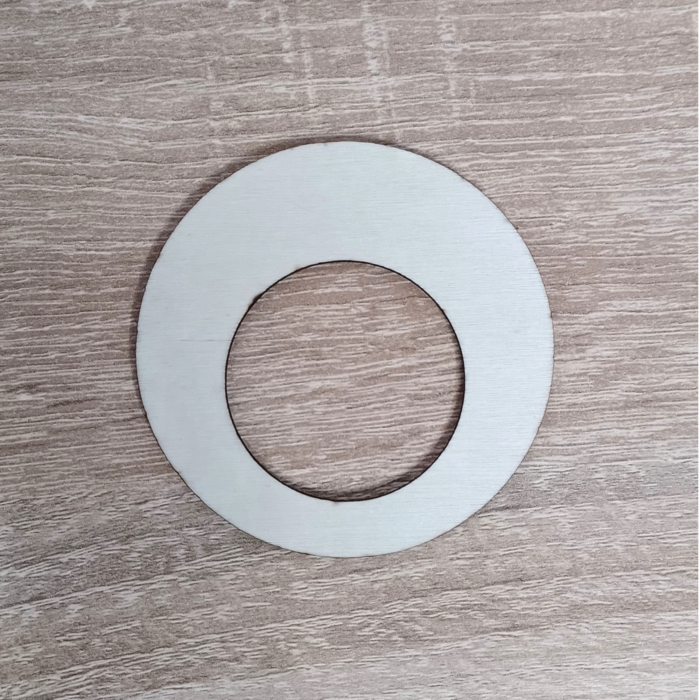 A plywood ring placed on a wooden surface