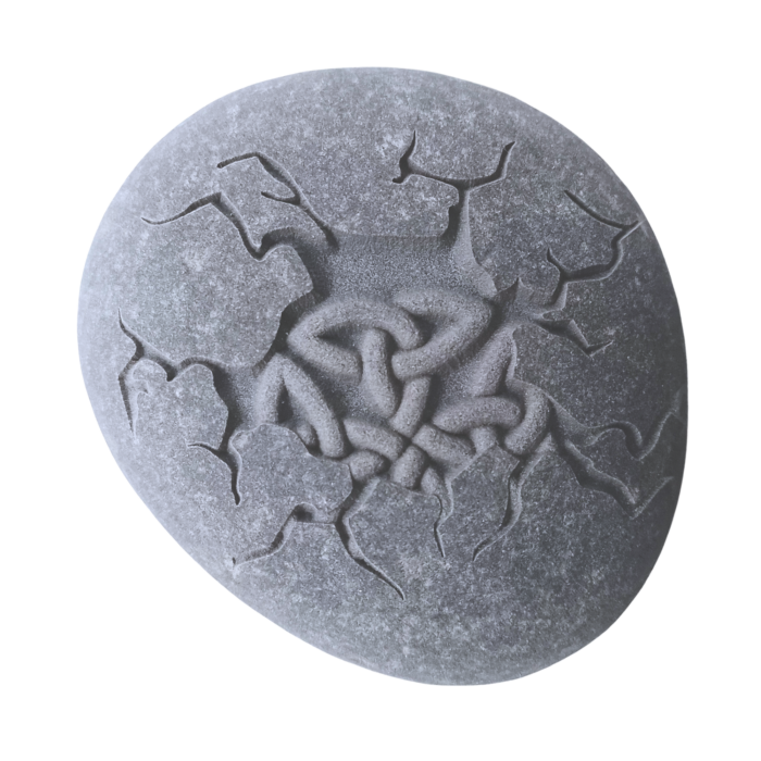 Engraved natural stone featuring a detailed Celtic knot within a cracked stone effect, symbolising strength and eternity.
