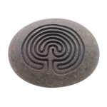 A natural stone engraved with the ancient Cretan labyrinth, symbolising guidance and self-discovery.