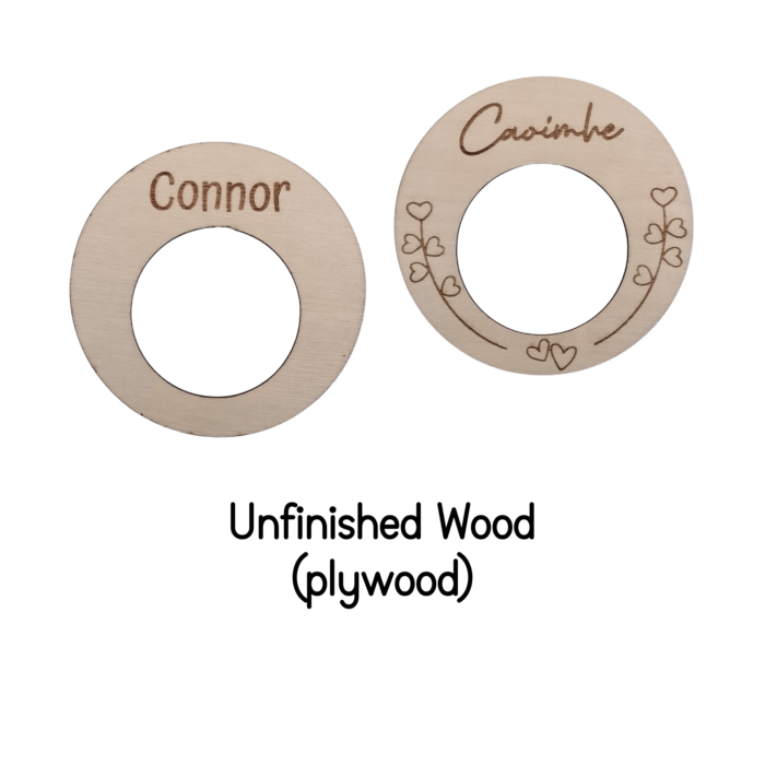 Close-up of unfinished wooden napkin ring with engraved name and heart design.