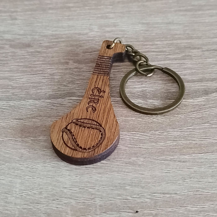 Hurley keychain with Éire engraving placed on a wooden surface