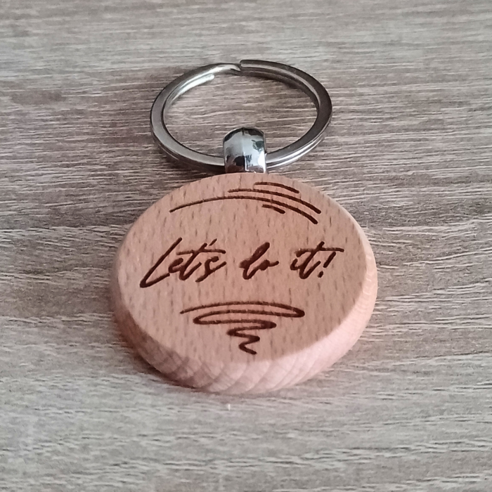 Close-up of "Let's Do It" side of the wooden keychain