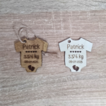 Side-by-side comparison of oak-stained and unfinished wooden baby onesie tags.