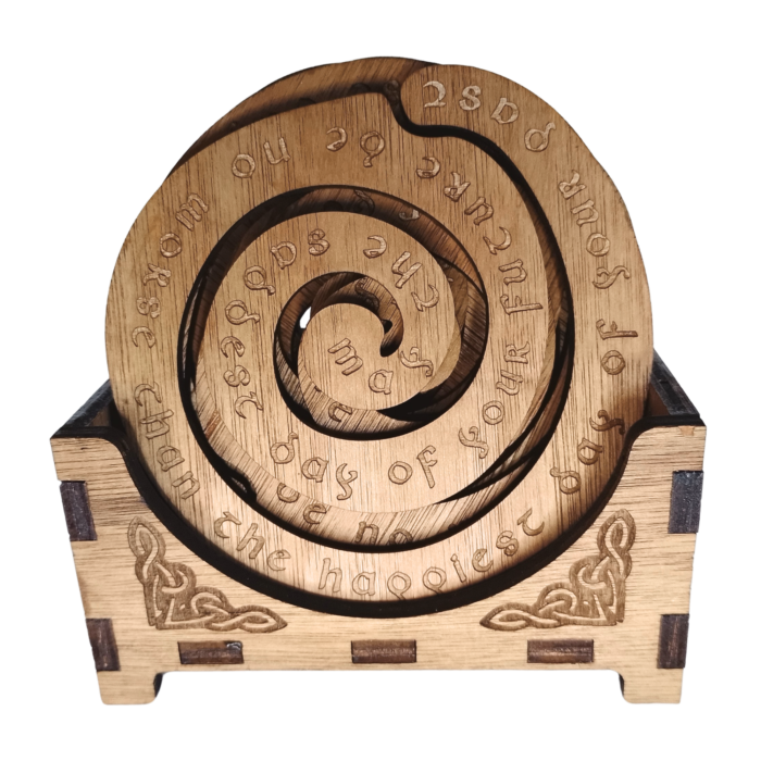 Front view of the coaster set in its storage box, featuring Celtic engravings and an inspirational quote.