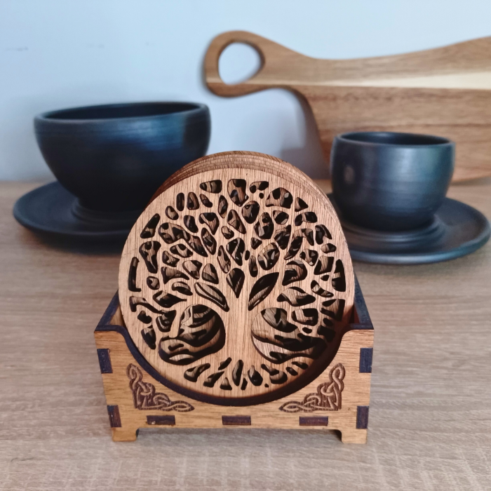 Set of 6 Tree of Life wooden coasters in a Celtic-inspired storage box, displayed with ceramic cups.