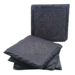 A square slate coaster engraved with a Celtic Cross design, displayed upright with other coasters stacked beneath.