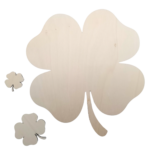 Close-up of various laser-cut plywood shamrocks on a transparent background