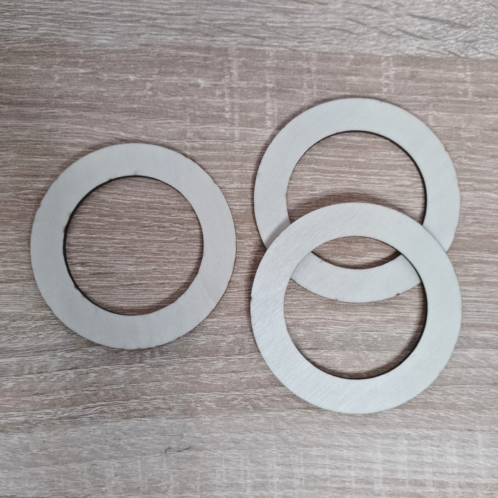 Three plywood rings placed on a wooden surface