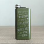 Army Green custom flask with humorous engraved Irish toast standing on wooden table.