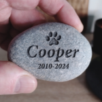 Personalised Pet Memorial Stone - Pet memorial stone held in hand, showing engraved details.