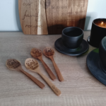 Set of engraved wooden spoons displayed on a table - personalised gift spoon.